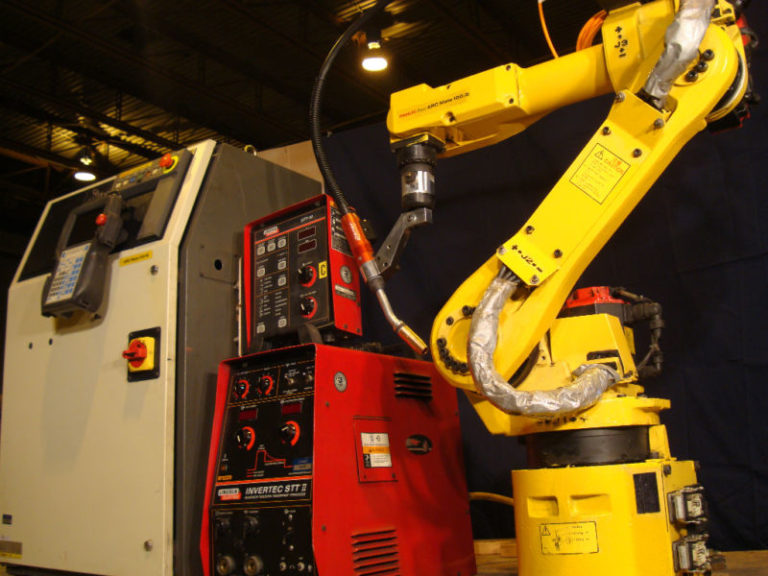 Refurbished FANUC welding robot performing automated arc welding – Universal Robotic INC